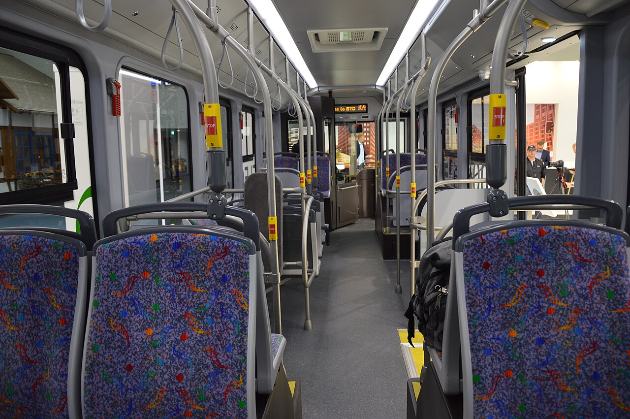 Seating and grab rails inside an air-conditioned electric bus