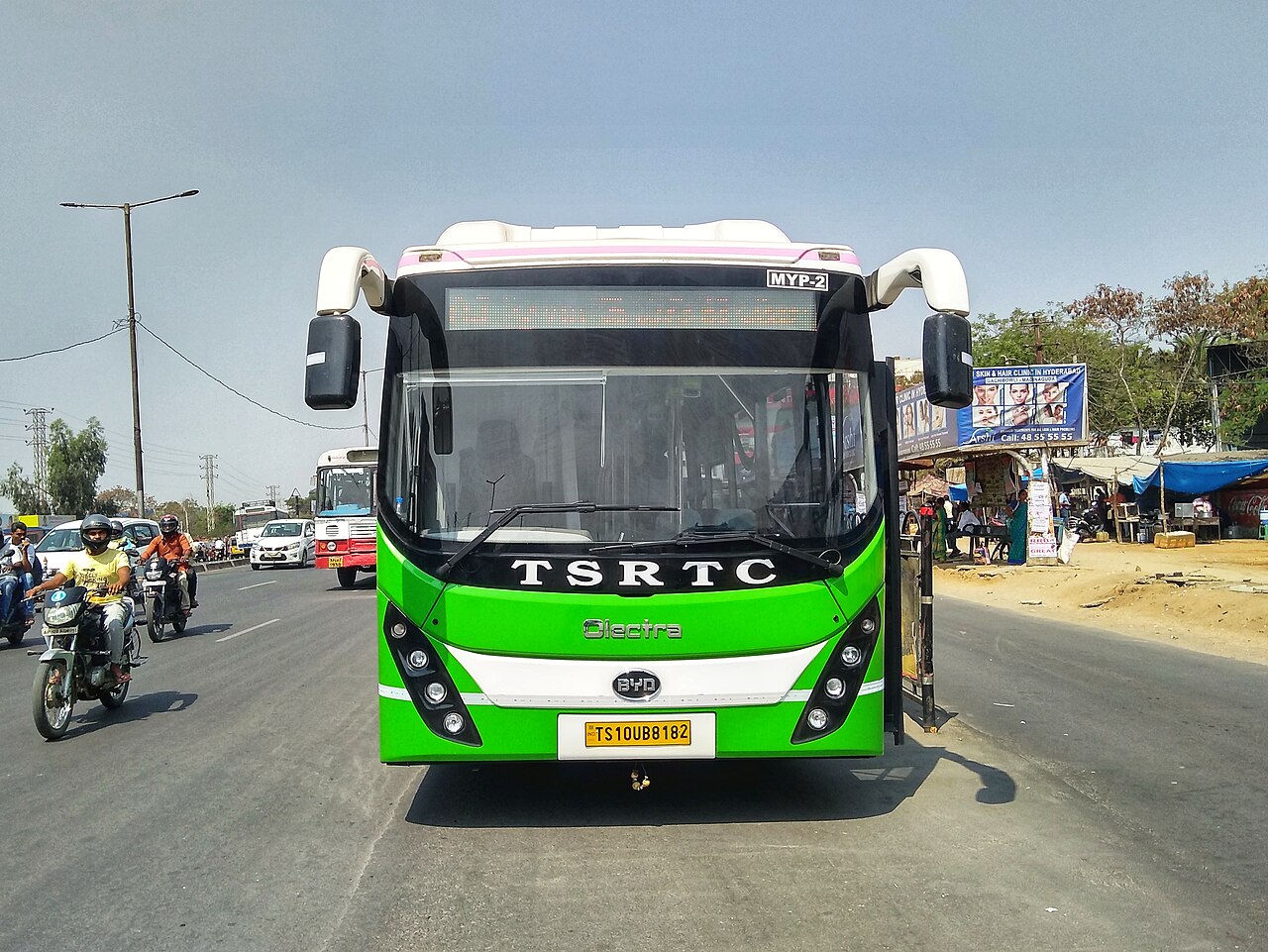 Electric bus running a city route in traffic