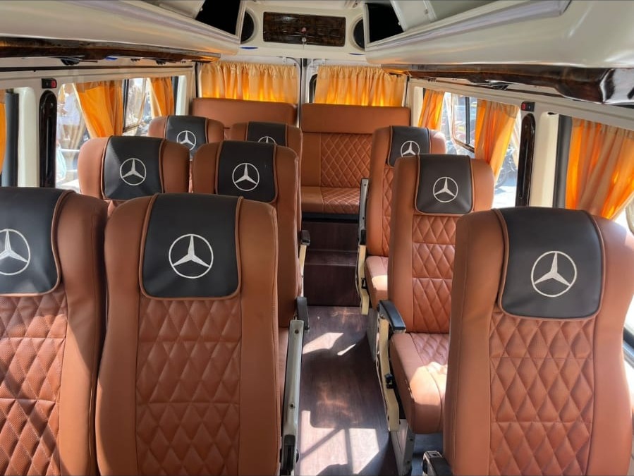 Quilted pushback seats and curtains inside a Nishnai Force Tempo Traveller