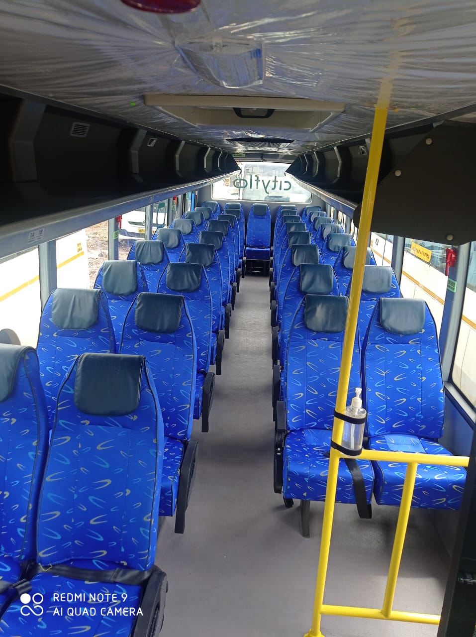 Seating inside a Nishnai 35 seater AC coach used for daily employee commute routes